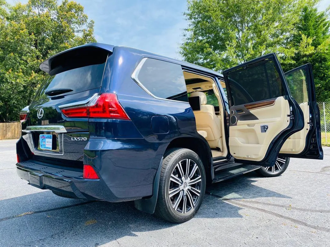 Navy blue Lexus LX 570 rear three-quarter view with doors open, tan leather interior